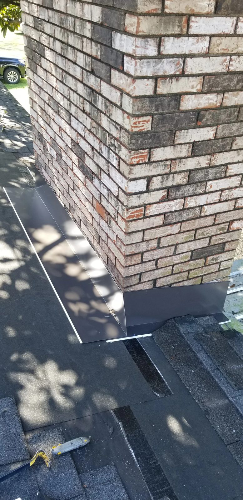 New metal chimney flashing being fitted