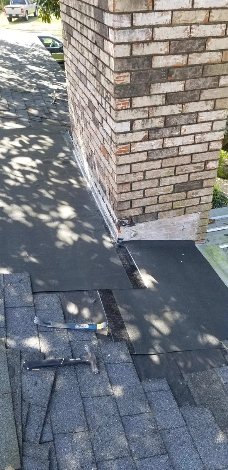 Waterproof underlayment installed around chimney base